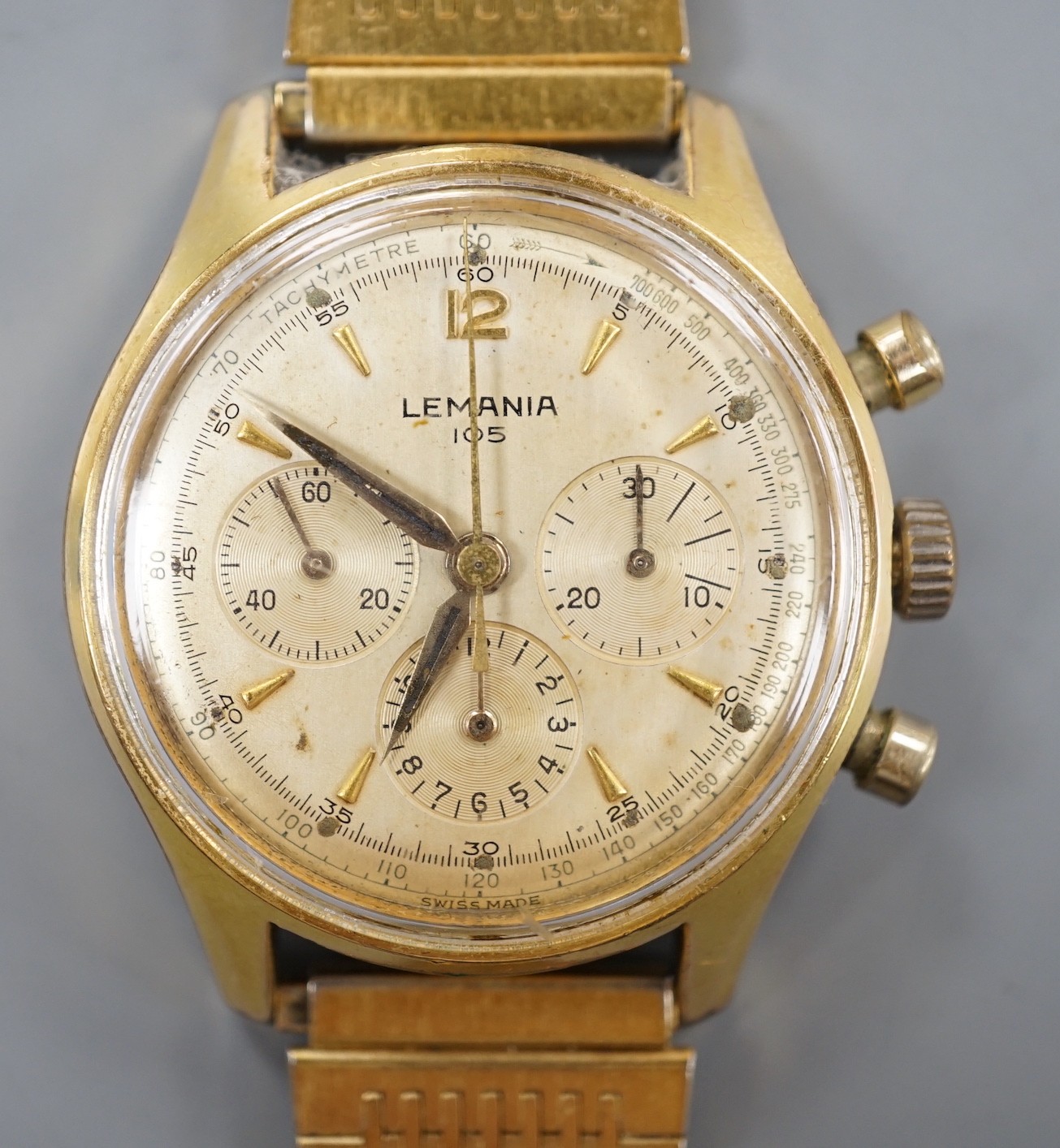 A gentleman's mid 20th century Lemania 105 steel and gold plated chronograph wrist watch, on associated steel and gold plated bracelet.